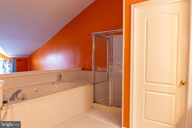 bathroom with vaulted ceiling, tile patterned floors, and separate shower and tub