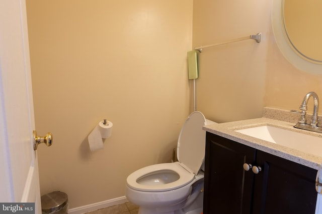 bathroom with vanity, tile patterned floors, and toilet