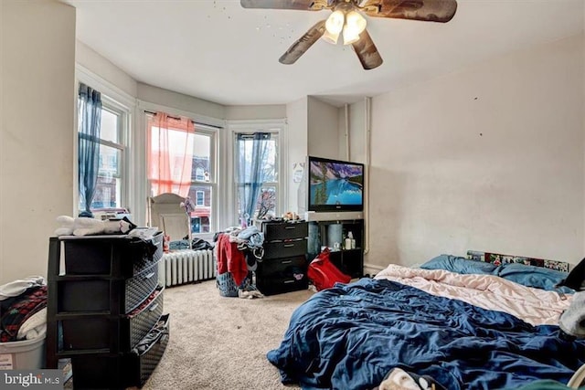 bedroom featuring ceiling fan, carpet flooring, and radiator