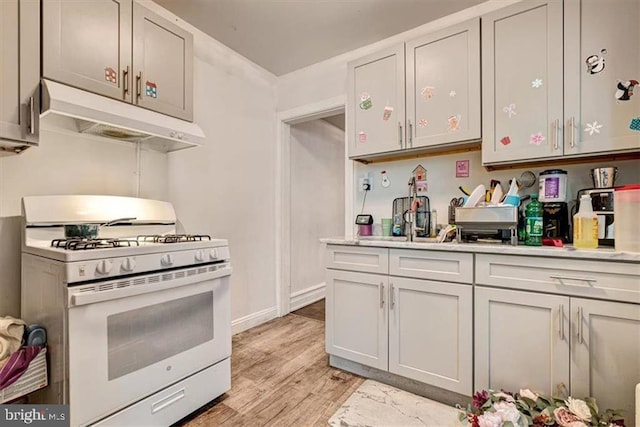 kitchen featuring light hardwood / wood-style flooring and white range with gas stovetop