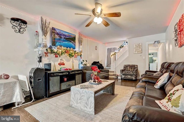 living room with hardwood / wood-style flooring and ceiling fan