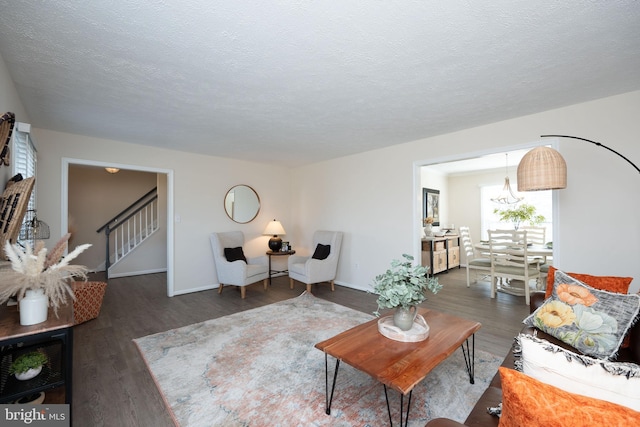 living room with dark wood-type flooring and a textured ceiling