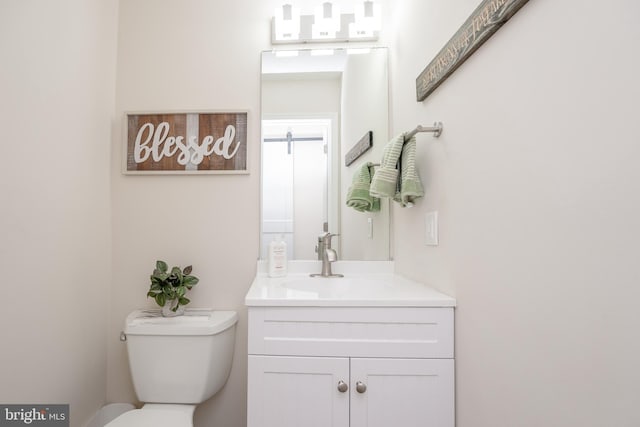 bathroom featuring vanity and toilet