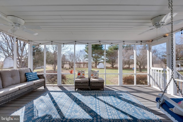 unfurnished sunroom featuring ceiling fan