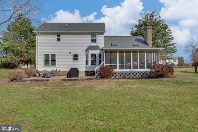 back of property featuring a patio area, a sunroom, and a lawn