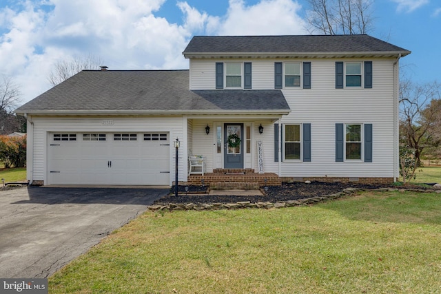 view of front of home featuring a garage and a front yard