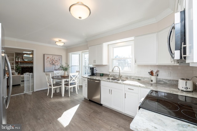 kitchen with appliances with stainless steel finishes, sink, dark wood-type flooring, and white cabinets