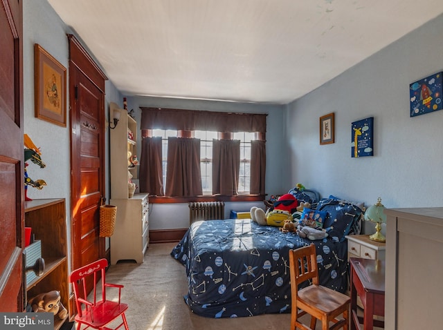 bedroom with radiator and light carpet