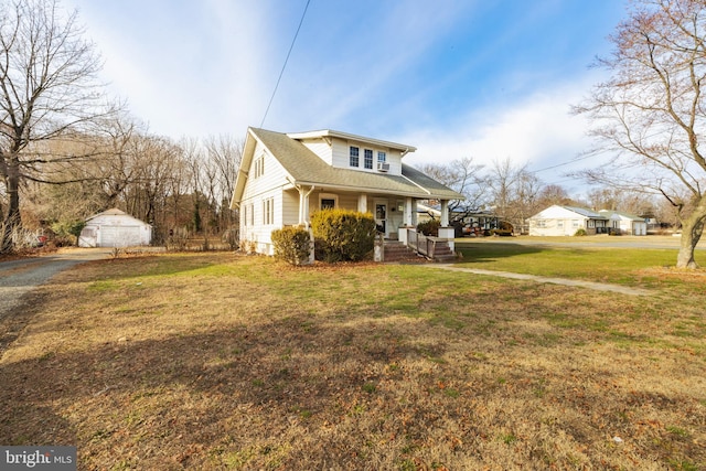 front of property with a front lawn, covered porch, and a shed