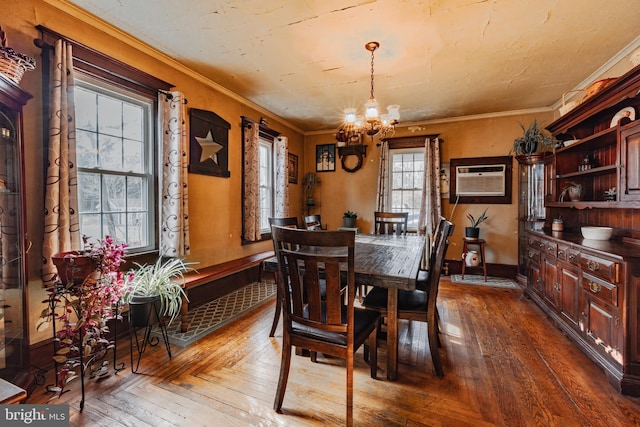 dining space featuring a chandelier, ornamental molding, dark hardwood / wood-style floors, and a wall mounted AC