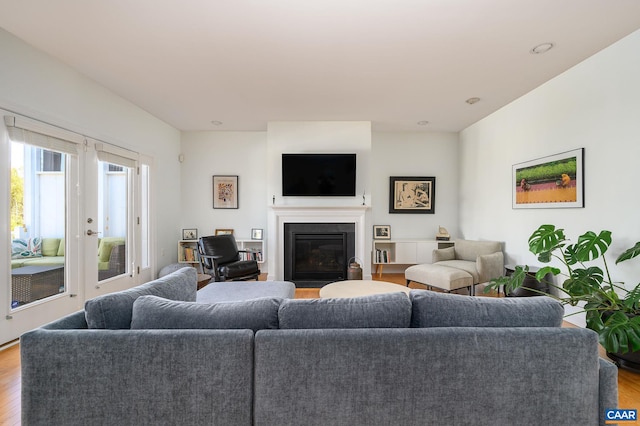 living room featuring light wood-type flooring and french doors