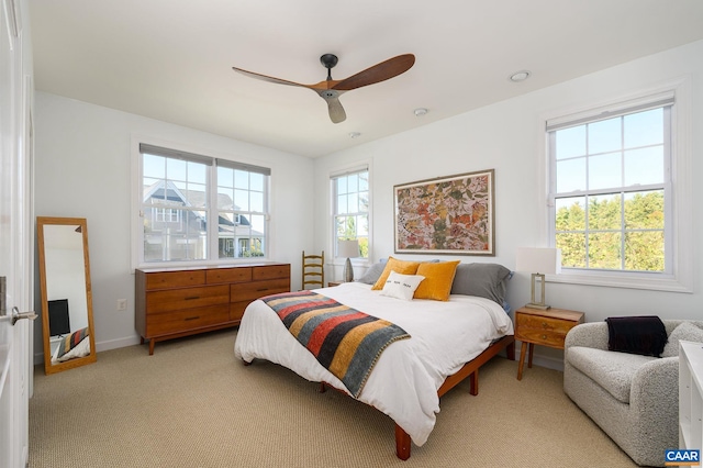 bedroom with ceiling fan and light colored carpet