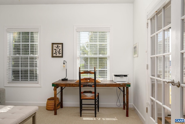 office with french doors and carpet floors