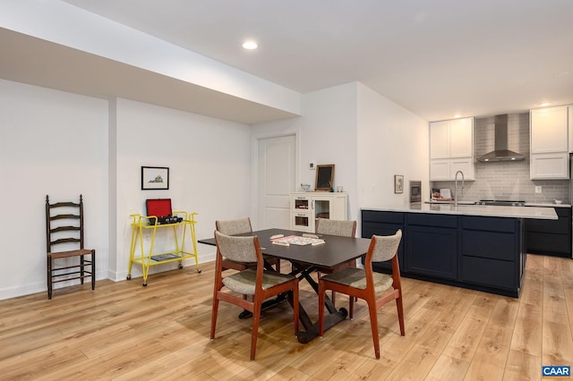 dining room with sink and light hardwood / wood-style flooring