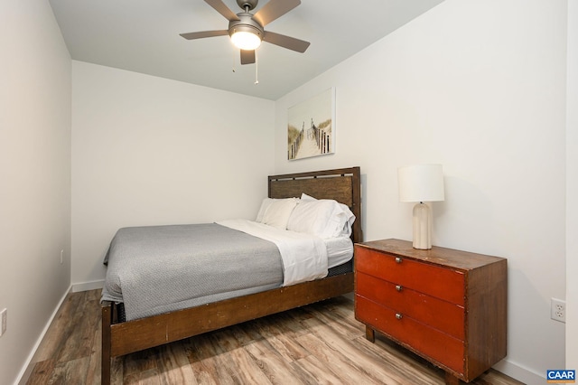 bedroom with ceiling fan and light wood-type flooring