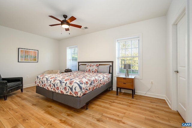 bedroom with ceiling fan and light hardwood / wood-style floors