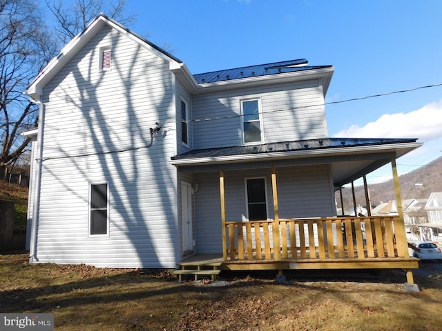 rear view of property with a porch