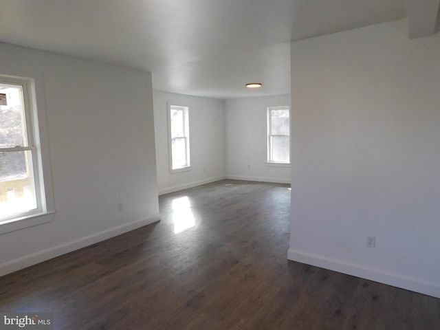 spare room with dark wood-type flooring