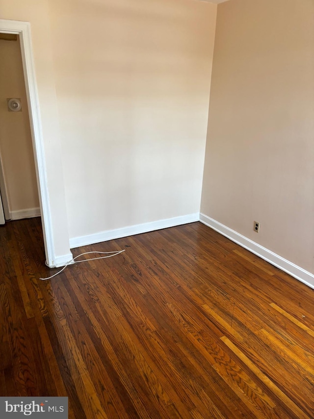 unfurnished room featuring dark hardwood / wood-style flooring