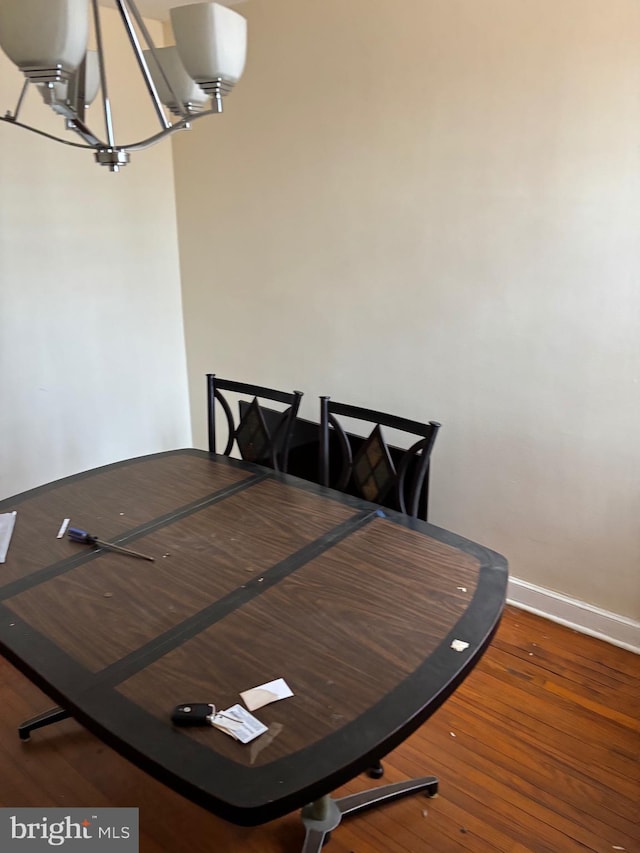 dining area with dark hardwood / wood-style flooring