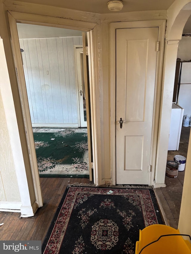 hallway with dark hardwood / wood-style floors