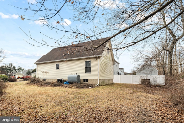 rear view of house featuring a yard