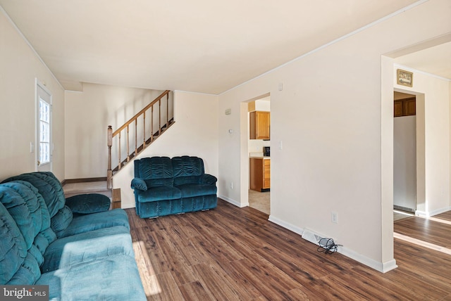 living room featuring crown molding and dark wood-type flooring