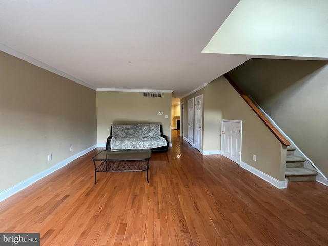 unfurnished bedroom with crown molding and wood-type flooring