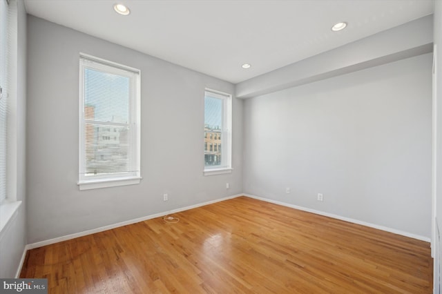 unfurnished room with hardwood / wood-style floors