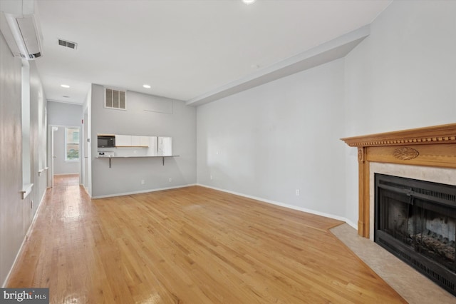 unfurnished living room featuring light hardwood / wood-style flooring