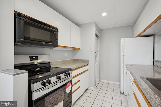 kitchen featuring white cabinetry, light tile patterned floors, white appliances, and sink