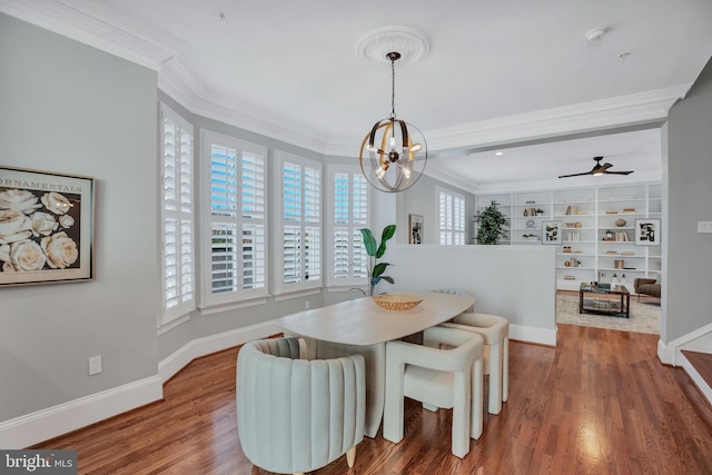 dining area with hardwood / wood-style floors, crown molding, and ceiling fan with notable chandelier