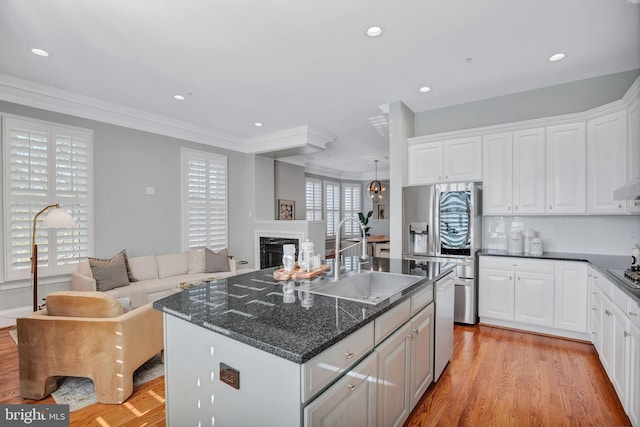 kitchen with white cabinetry, sink, and stainless steel fridge with ice dispenser