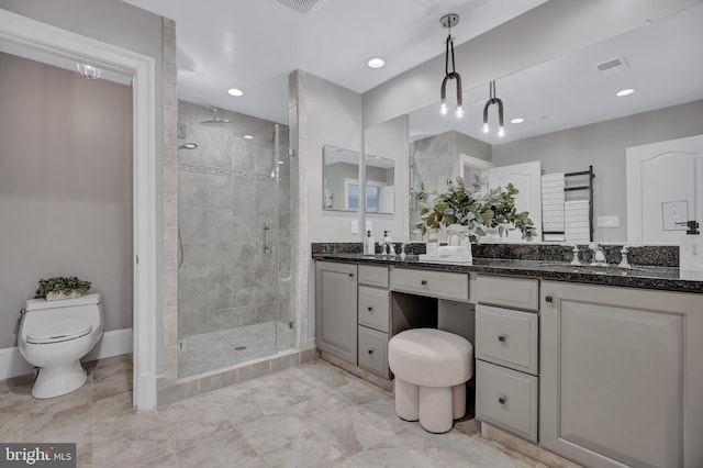 bathroom featuring an enclosed shower, vanity, and toilet