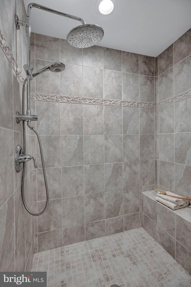 bathroom with a tile shower