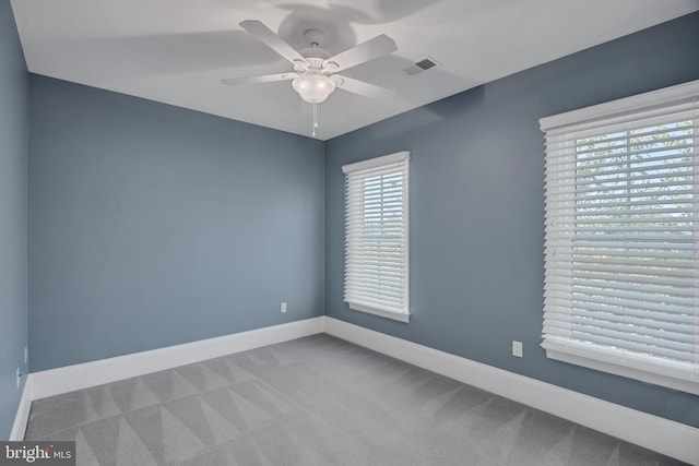 empty room with ceiling fan and carpet flooring