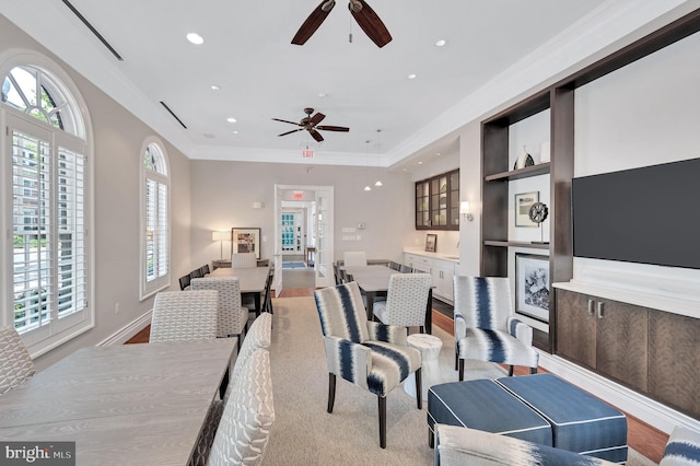 living room with crown molding and built in features