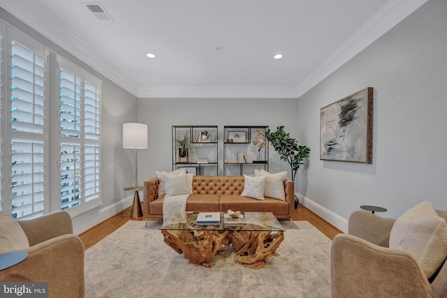 living room with crown molding and light wood-type flooring