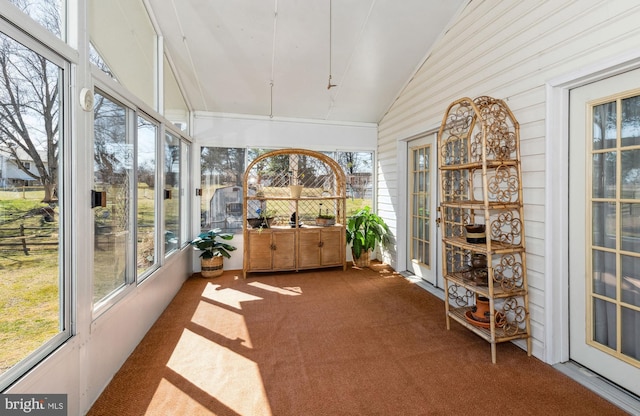 unfurnished sunroom with vaulted ceiling