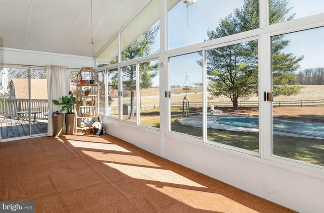 unfurnished sunroom with lofted ceiling