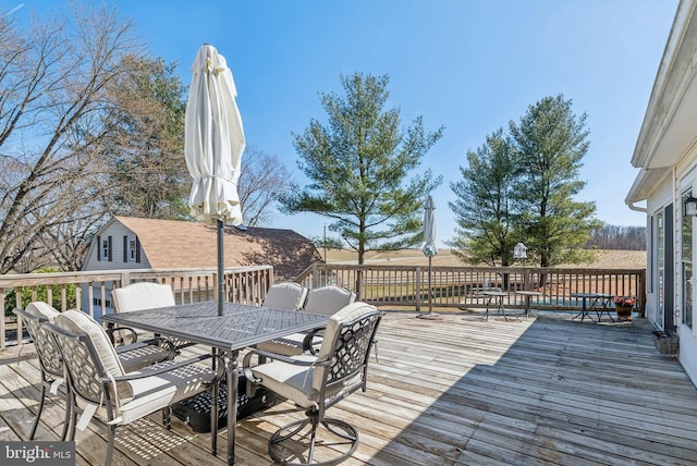 wooden deck featuring outdoor dining area