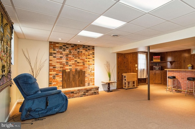 living area with visible vents, a bar, a brick fireplace, and carpet flooring