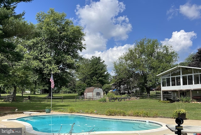 outdoor pool featuring a yard, fence, and a sunroom