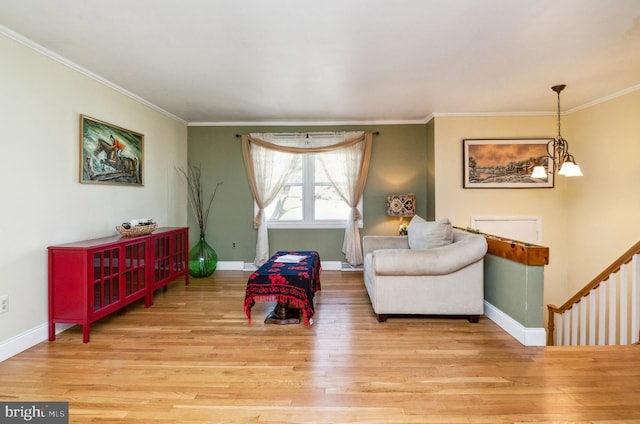 sitting room with baseboards, an inviting chandelier, and wood finished floors