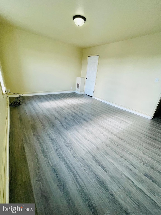 spare room with hardwood / wood-style flooring