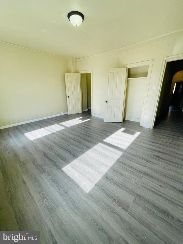 unfurnished bedroom with light hardwood / wood-style floors and a closet