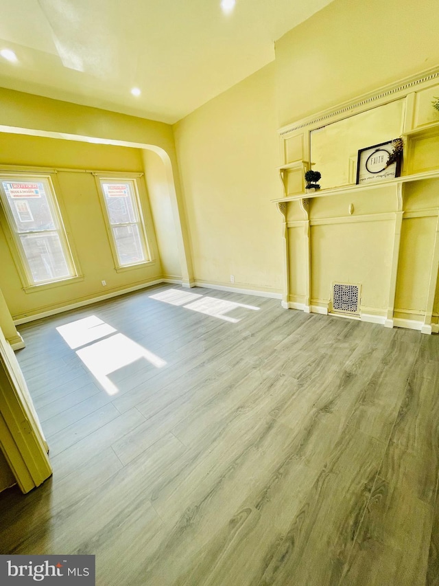 unfurnished living room featuring wood-type flooring