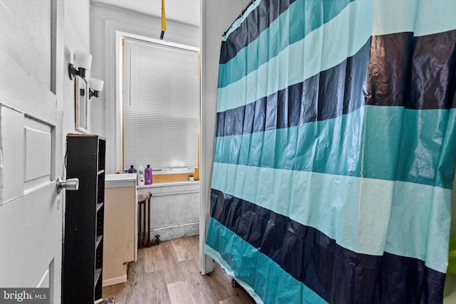 full bath with wood finished floors and a shower with shower curtain