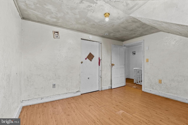 interior space with wood finished floors and baseboards