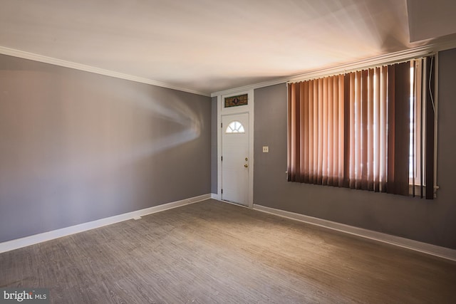 entrance foyer with wood-type flooring and crown molding